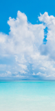 White clouds over a turquoise sea